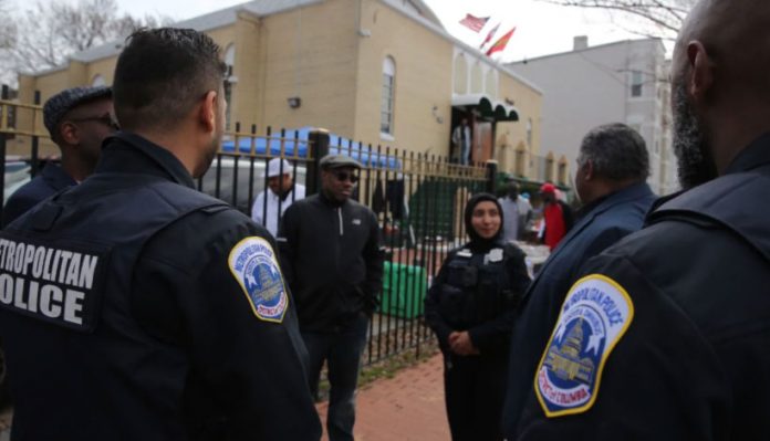 American-Muslims-anxiously-consider-security-needs-at-mosques-after-New-Zealand-shooting D.C. police officers stand guard at Masjid Muhammad mosque on Friday. (Oliver Contreras/for The Washington Post)